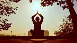 Woman Doing Yoga In Front of The Setting Sun