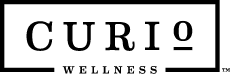 Curio Wellness cannabis dispensary logo with horizontal line dividers
