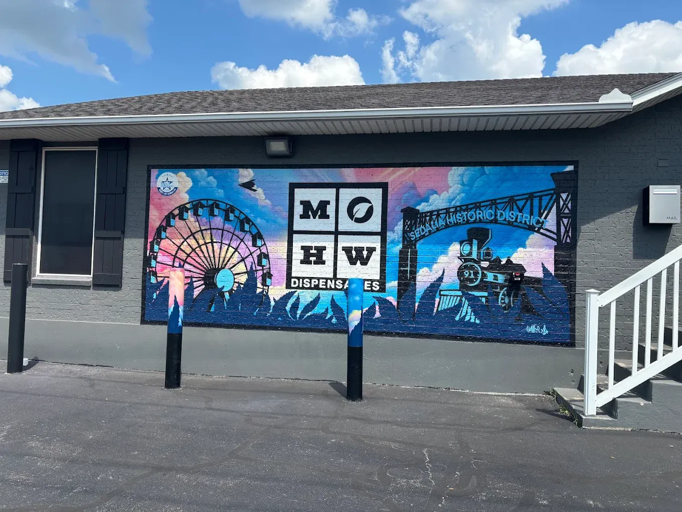 # Alt Text
Sedalia cannabis dispensary storefront with blue and pink branded murals on exterior wall