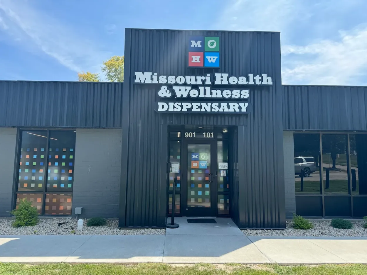 # Alt Text
Exterior storefront of Missouri cannabis dispensary with dark gray metal siding and entrance doors